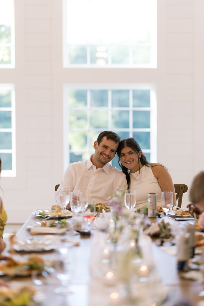 candid moments between guests during wedding rehearsal dinner