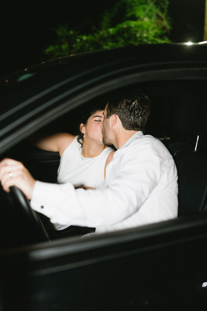 bride and groom in their getaway car