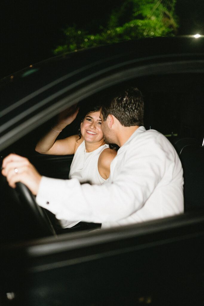 bride and groom in their getaway car