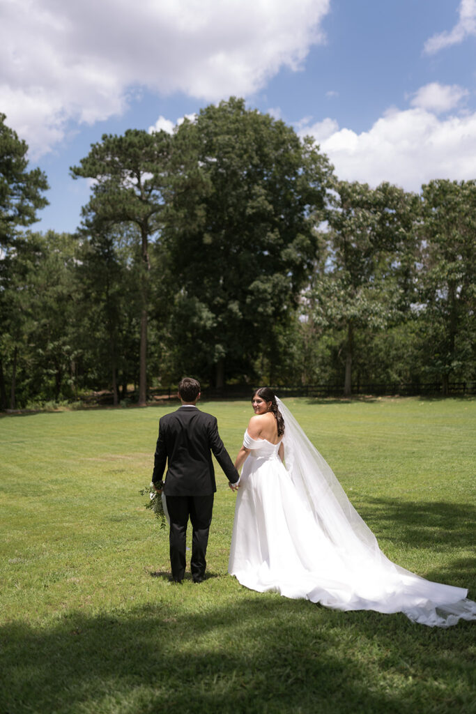 bride and groom walking around the Heron Hill property for their photos