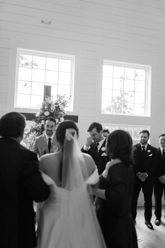 bride walking down the aisle with her parents